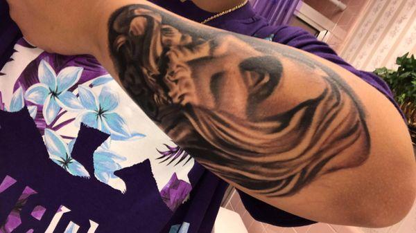 Jesus and angel tattoo done by Miguel Alaniz