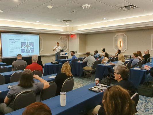 Tim Jedrek giving a talk about developing a flight school marketing system to grow flight schools and enroll more students.