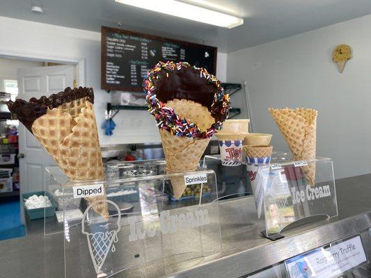 In-House made waffle cones. Options are plain, dipped in chocolate with or without sprinkles.