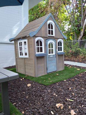 Adorable playhouse in our spacious outdoor play space!