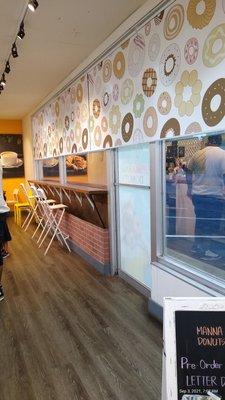 Nice wooden floors, small bar, cute Donut Wallpaper.