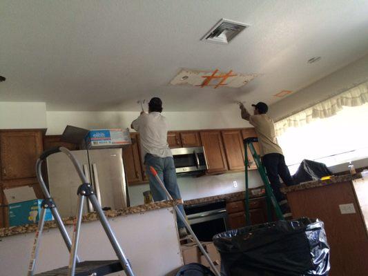 The guys working on running wiring for my recessed lighting