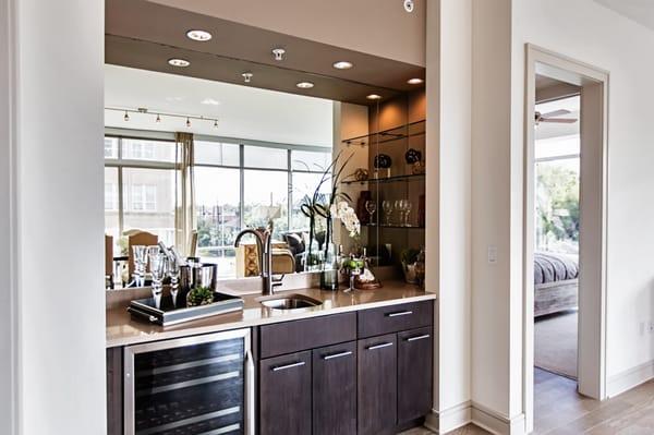 Many homes offer dry or wet bars, with dual-temperature wine fridges available in select floor plans.