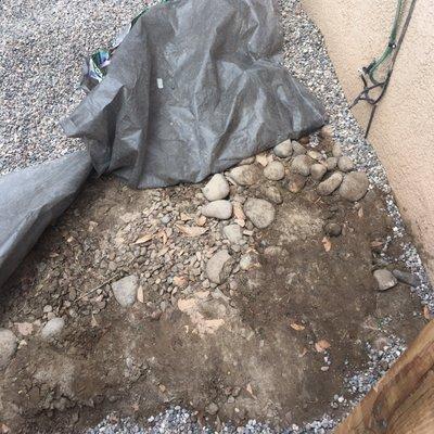 Tried to hide old river rock from yard in dog run and filled with about 6 inches of gravel to cover it all up