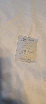 Silica gel packet found underneath the mattress.