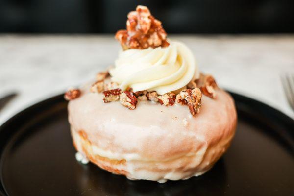 Maple Glazed Donut with spiced pecans, vanilla buttercream, and pecan praline