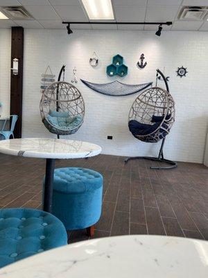 Hammock chairs with a nautical themed wall