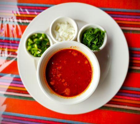 Consume soup for the Birria Tacos with additional garnished