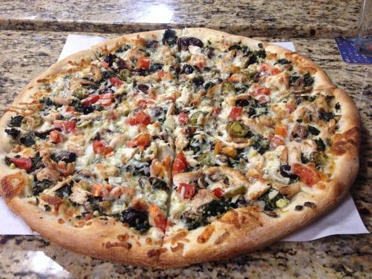 specialty pizza with spinach tomatoes garlic jalapenos onions and mushrooms!