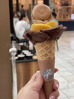 Chocolate,mango, and hazelnut topped with a chocolate macaron