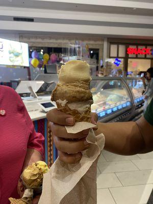 Three ice cream scoops in a cone