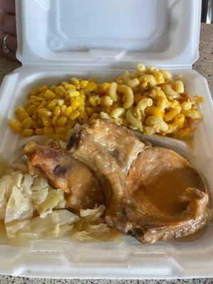 Pork chops, cabbage, Mac and Cheese, and corn.