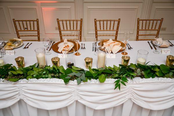 The gold receptacles on the head table were used to hold our bouquets.