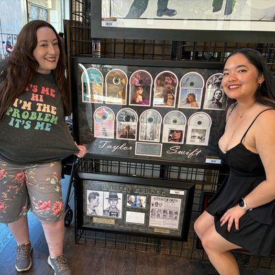 Swifties checking out the very best autographed memorabilia of Taylor Swift featuring all of her albums in 1 framed collage!