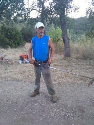 Lance Williams posing with his STIHL Weedeater On A Job Site