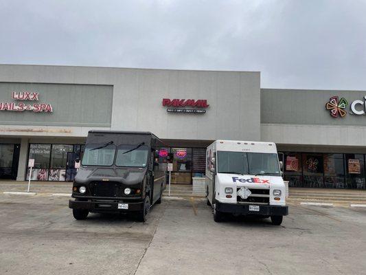 Our UPS and FedEx Ground drivers picking up from our store today's outgoing packages in this cloudy day.