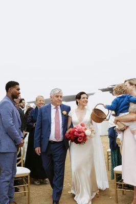 Father walks bride down the aisle at her wedding