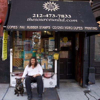 The Source Unltd Print & Copy Shop NYC with owner Santo and best friend Clyde in front of their store.