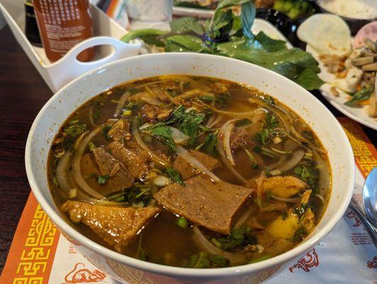 Spicy Veggie Beef Noodle (Bún Bò Huế)  Big rice noodles,veggies beef,tofu,Mushroom veggie ham and fresh vegetables.