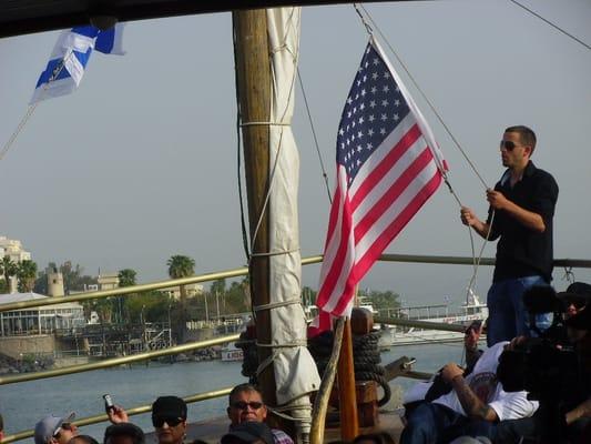 An American flag is hoisted next to the Israel flag before prayer on the Sea of Galilee