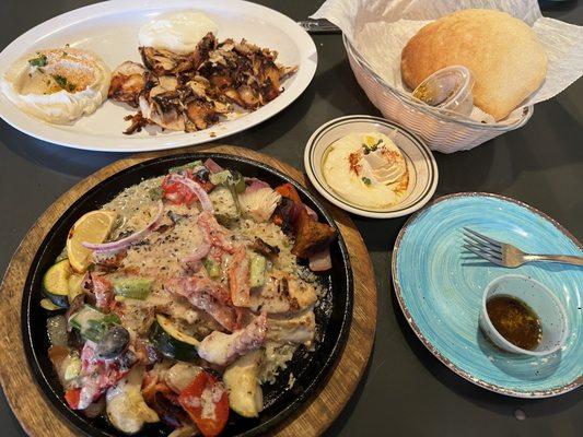 Red fish and chicken plate with humus and pita bread