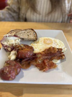 Over easy eggs, bacon, smashed potatoes and sourdough toast.