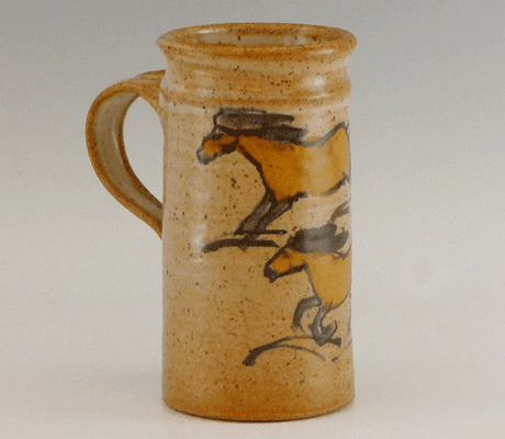 Wheel thrown tall mug with brush drawn horse design. $26