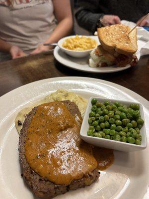 Meatloaf special with creamy mashed potatoes and crisp peas. Delicious!