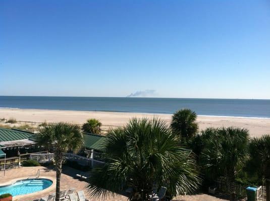 view of pools and ocean from unit