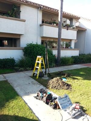 Repairing broken under ground electrical conduit and wiring.  At a apartment building.