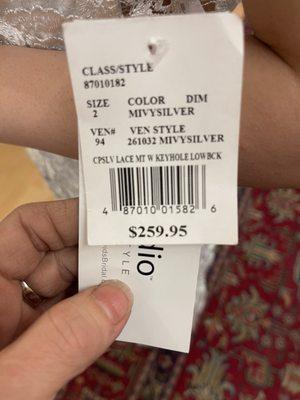 This was the tag on the dress & we had David's bridal scan it. Her "vintage" & elegant gowns are at best discounted clearance!