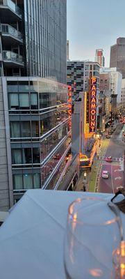 View, from our table, of Washington Street and the Paramount Theater, f