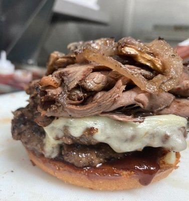 Mrs Bully Boss Burger topped with sliced roast beef, sauteed onions and sweet bbq sauce