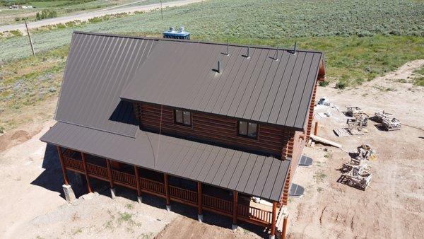 New standing seam metal roof install to protect this new log home from the Kemmerer, WY winters.