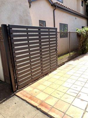 Contemporary Swing side gate. 
Metal frame with cedar wood and laminated glass