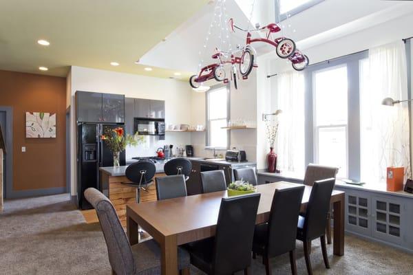 Dining room of Shift Vacation Rentals- High Gear. There is a modern open living, dining and kitchen configuration.