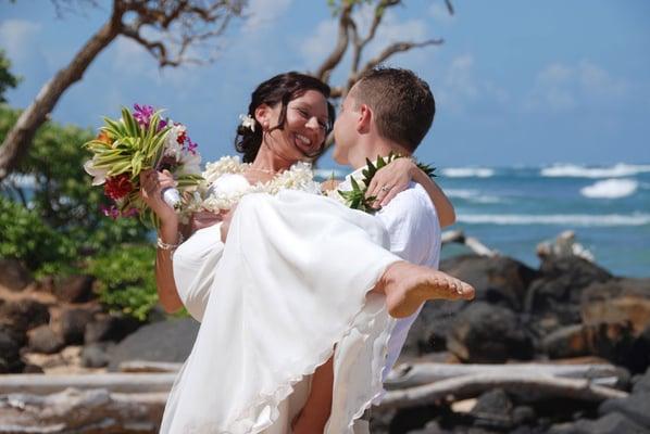 Enjoying an intimate moment after their wedding at Lydgate Beach.