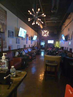 Inside the bar lounge where there are 2 rows of easy chairs plus tables