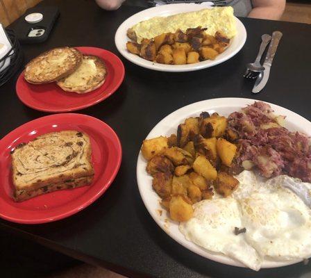 2 eggs, home fries and homemade hash with raisin toast.  A veggie omelette with home fries and English muffin