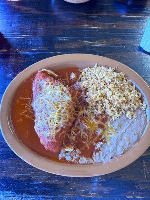 Stuffed sopapilla with chicken and red sauce, beans and rice