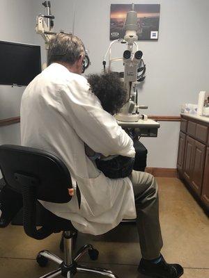 My 2 year old assisting Dr. Stanfield with an eye exam.