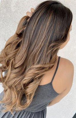 This beautiful balayage/ombré is also layered and glossed up with a sandy blonde. Paired perfectly with big and soft curls!