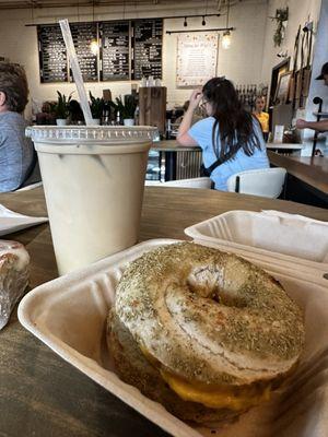 Maple brown sugar iced latte and a sausage egg and cheese on a rosemary sea salt bagel