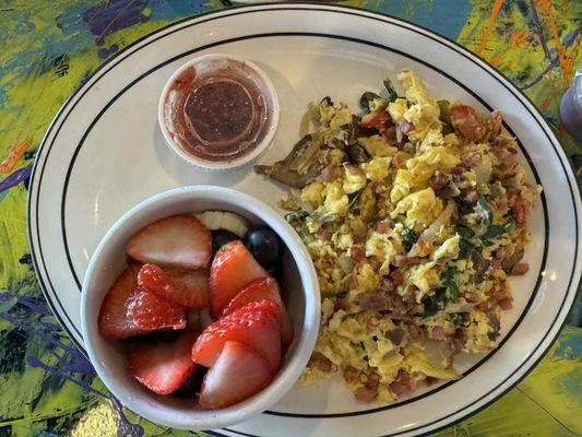 Ham and vegetable egg scramble with fresh fruit.