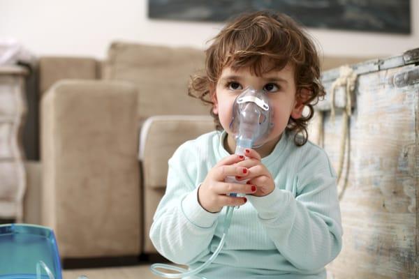 Young child getting a respiratory treatment.