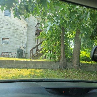 The parking lot, my spot, under the shade tree near a cool old house.