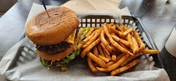 Combo Special of stacked tall ground beef burger with cheese & green chile, plus beer battered fries & a drink.