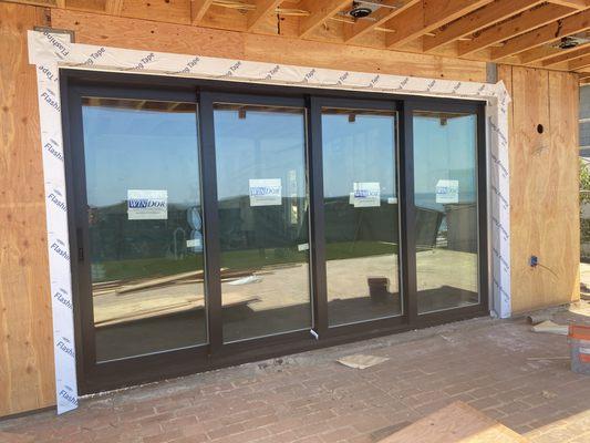 Multi panel sliding doors black exterior white interior