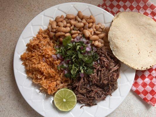 Barbacoa plate with beans, rice, and tortillas of your choice.