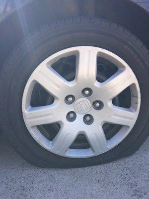 My tire was punctured by a giant nail and it was completely flat. (See next photo for the after)